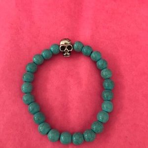 Turquoise bracelet with silver skull charm